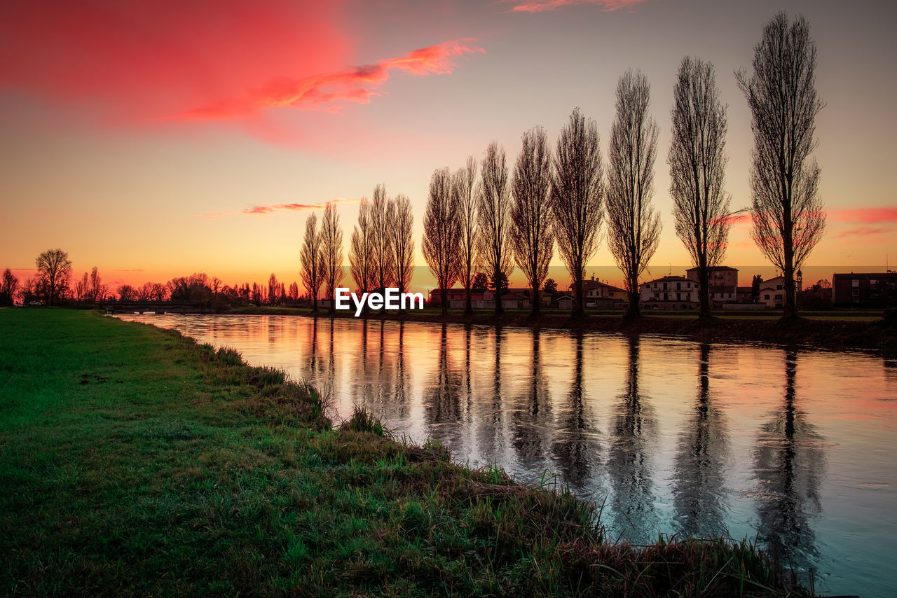 Sunset along the man-made canal po valley italian landscape