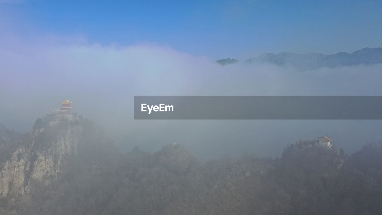 SCENIC VIEW OF MOUNTAINS AGAINST SKY DURING FOGGY WEATHER
