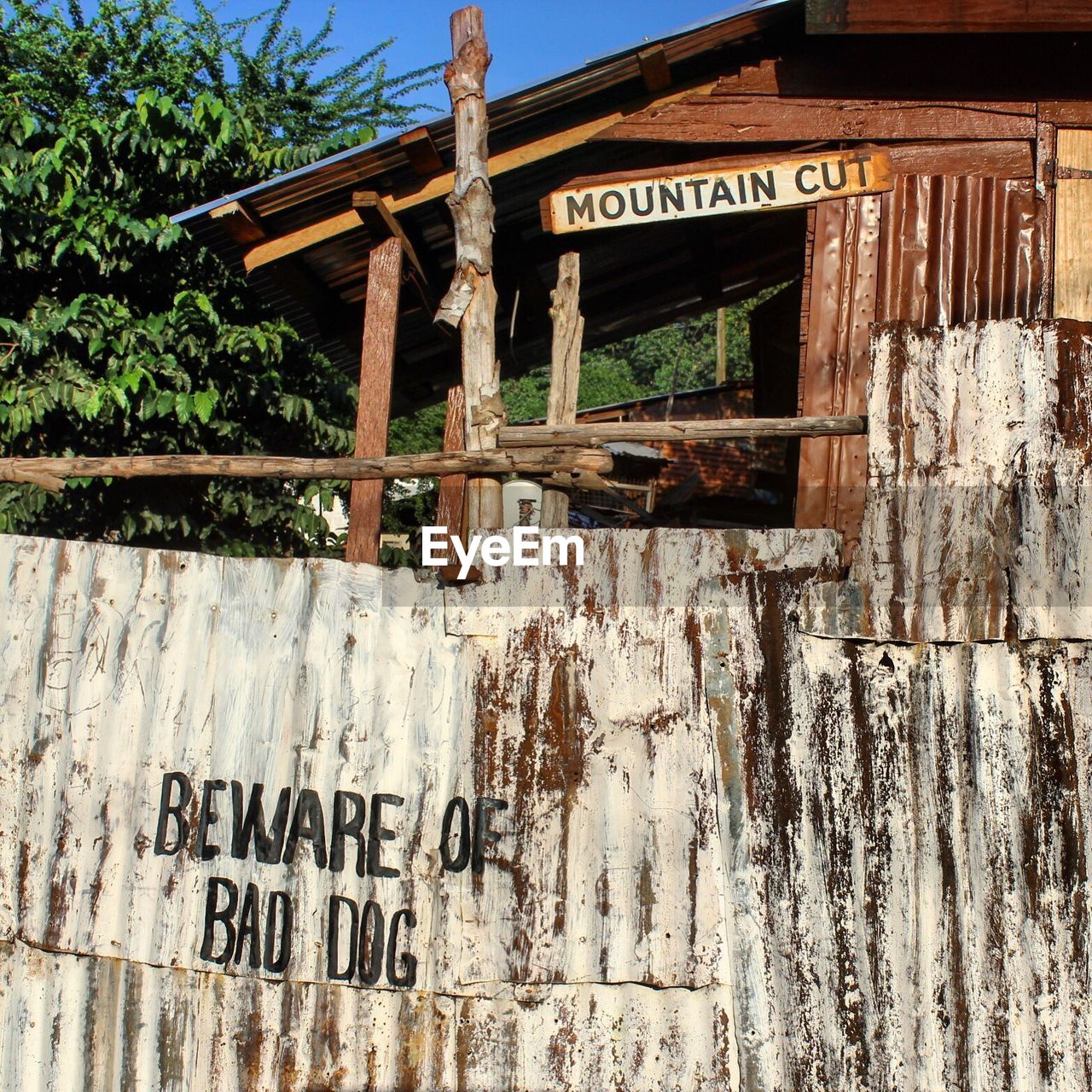 LOW ANGLE VIEW OF TEXT ON WOOD AGAINST WALL