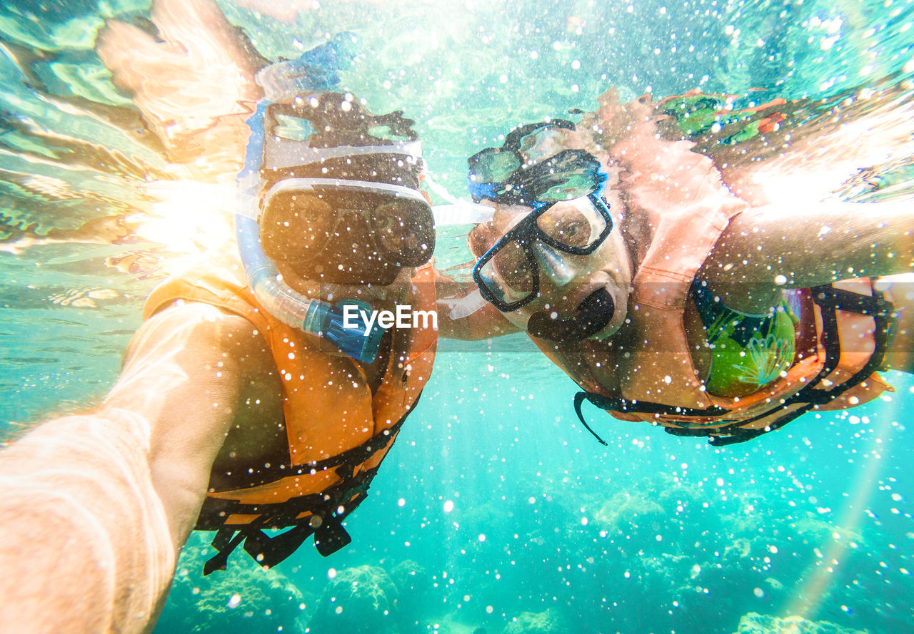 Couple snorkeling in sea