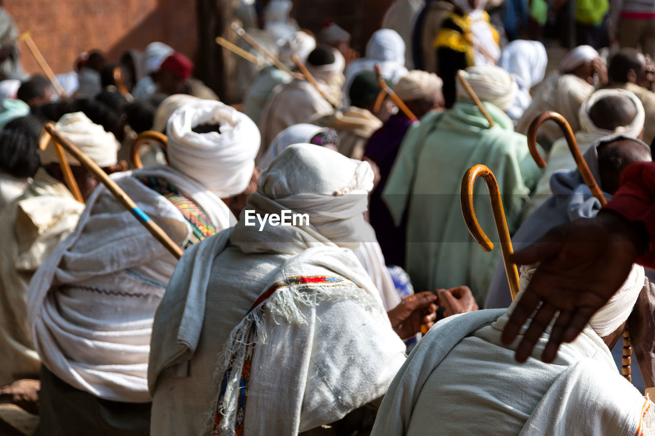 Rear view of people sitting on land