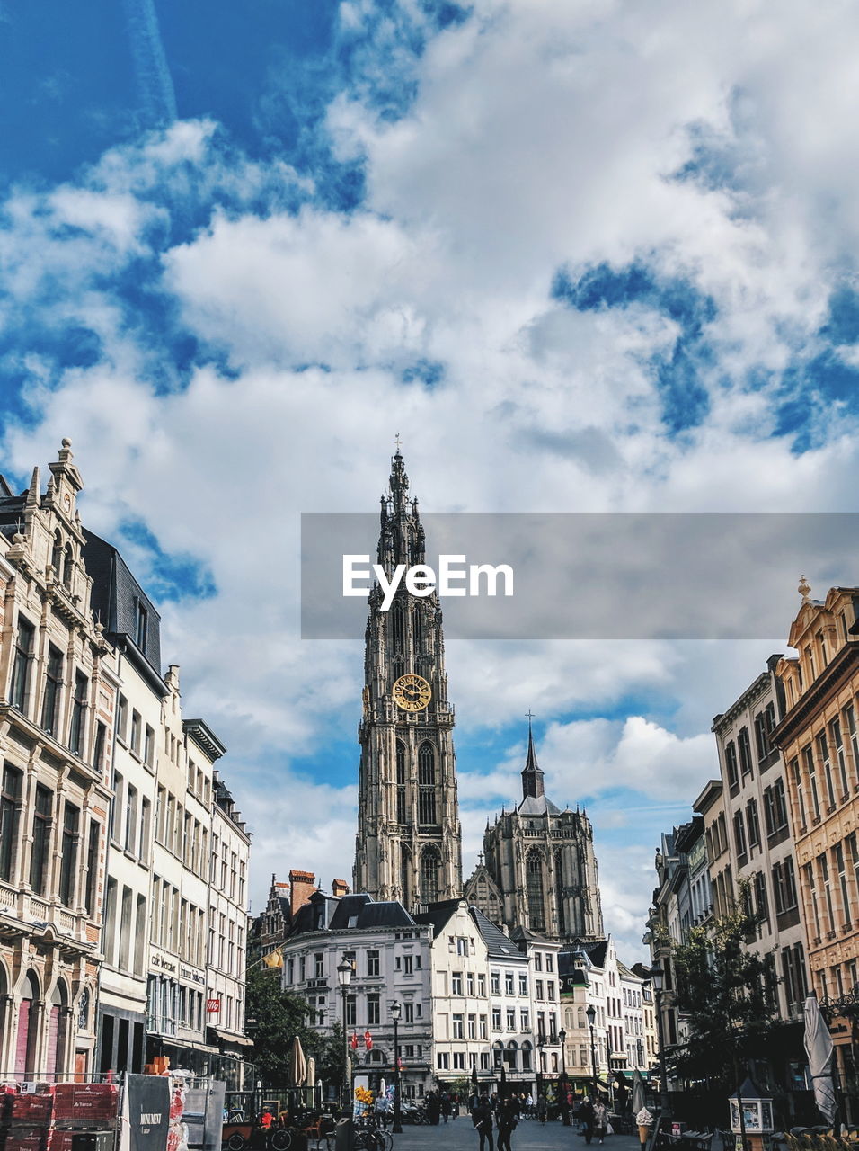 Low angle view of buildings in antwerp against cloudy sky