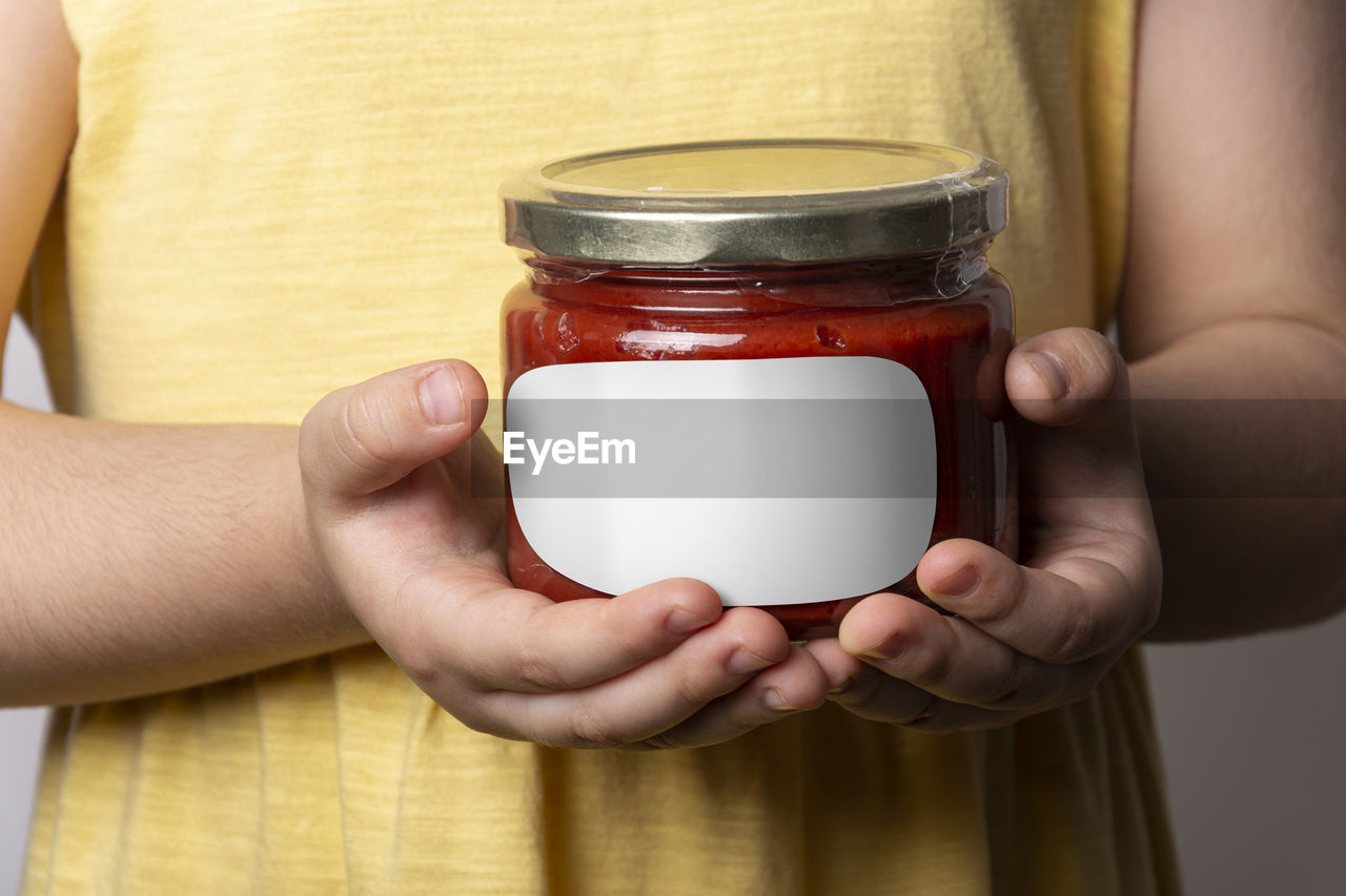 hand, holding, adult, one person, indoors, jar, midsection, close-up, food and drink, container, women, lighting, studio shot