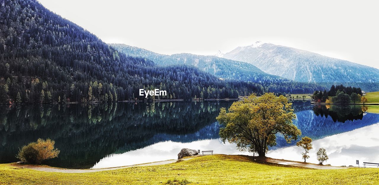 Scenic view of lake and mountains against sky