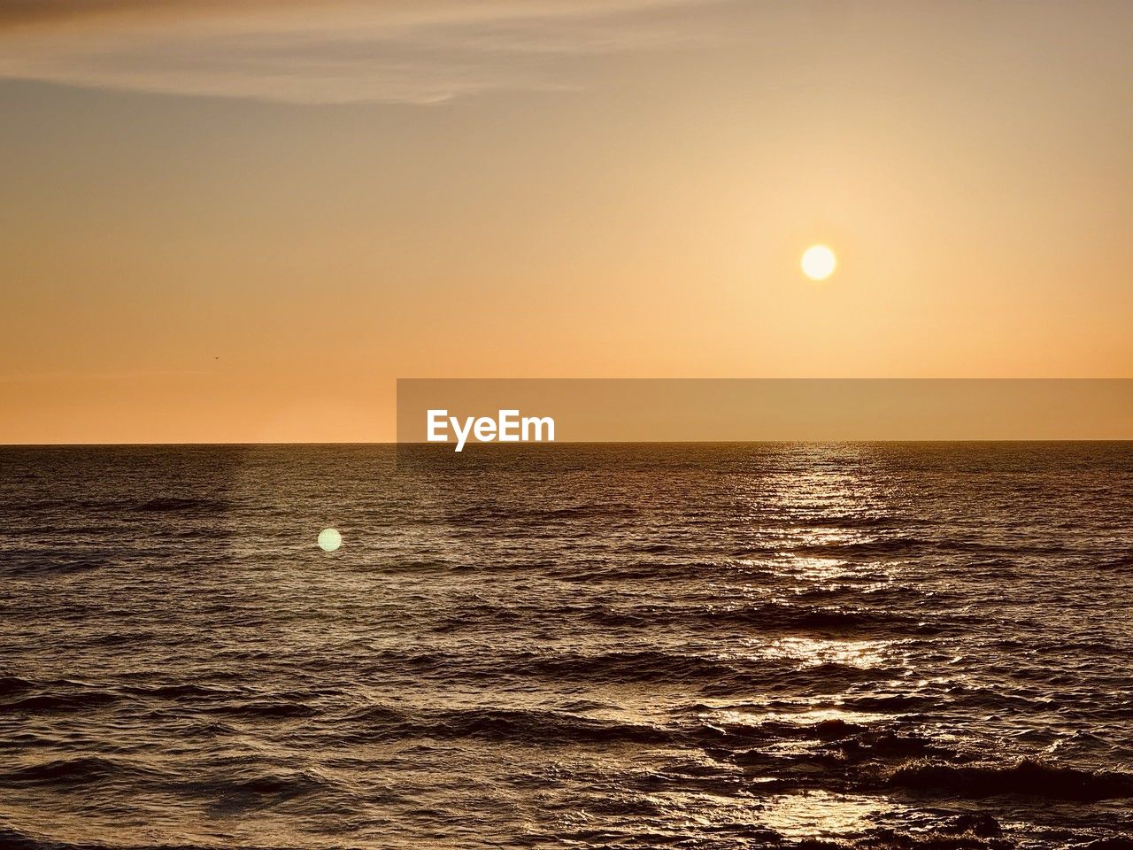sky, sea, water, sunset, beauty in nature, horizon over water, scenics - nature, horizon, tranquility, nature, sun, tranquil scene, ocean, sunlight, idyllic, land, orange color, seascape, no people, dramatic sky, environment, wave, dawn, outdoors, travel, evening, urban skyline, cloud, travel destinations, shore, reflection, afterglow, coast, beach, motion, astronomical object, vacation, non-urban scene, rippled, wind wave, trip, holiday, summer, landscape, awe, tourism