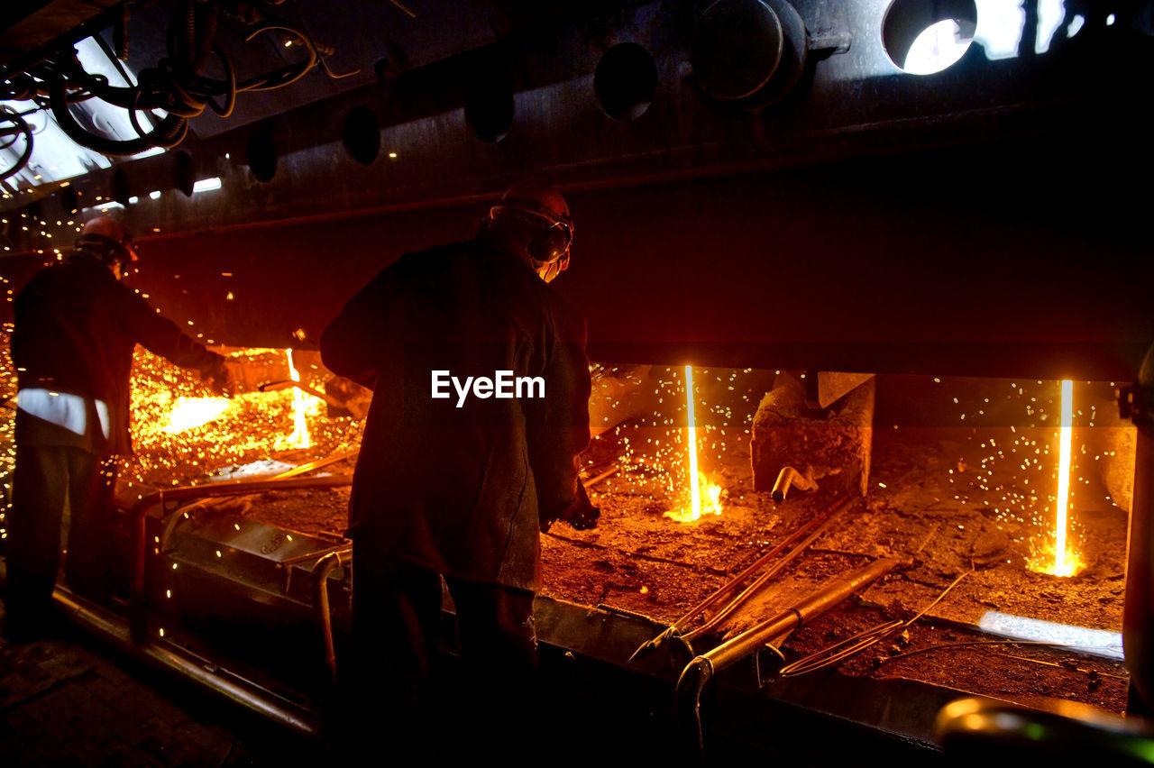 Workers welding in workshop