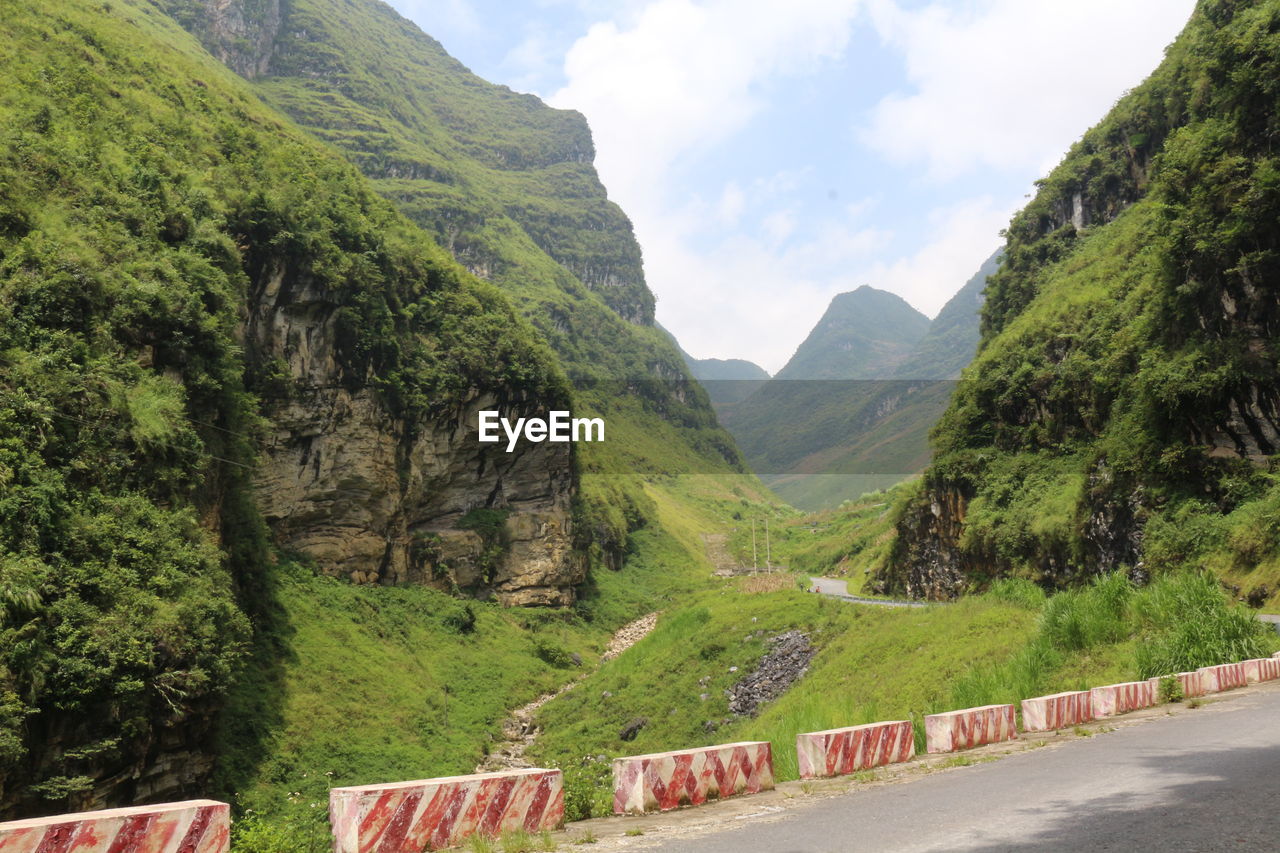 Scenic view of mountains against cloudy sky