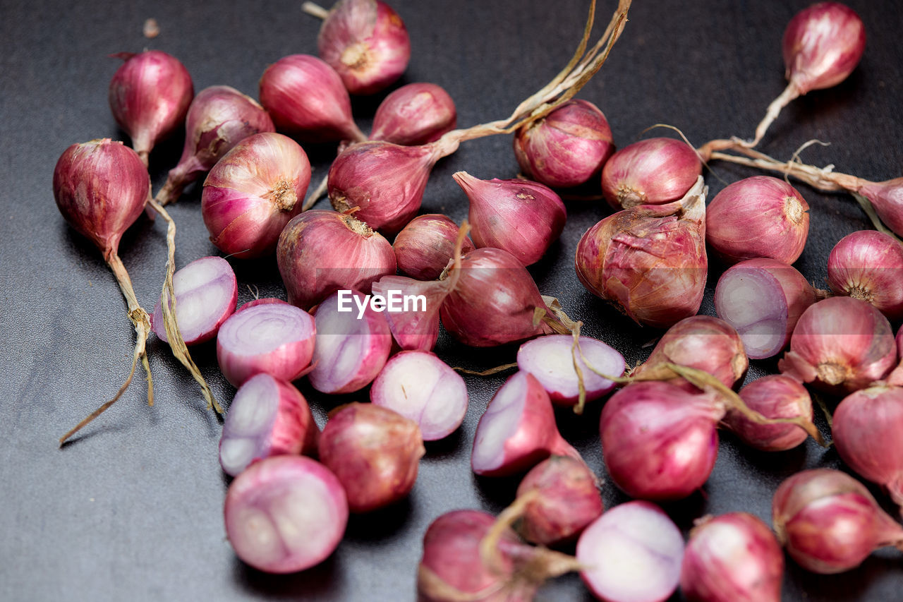 Red onions on black table