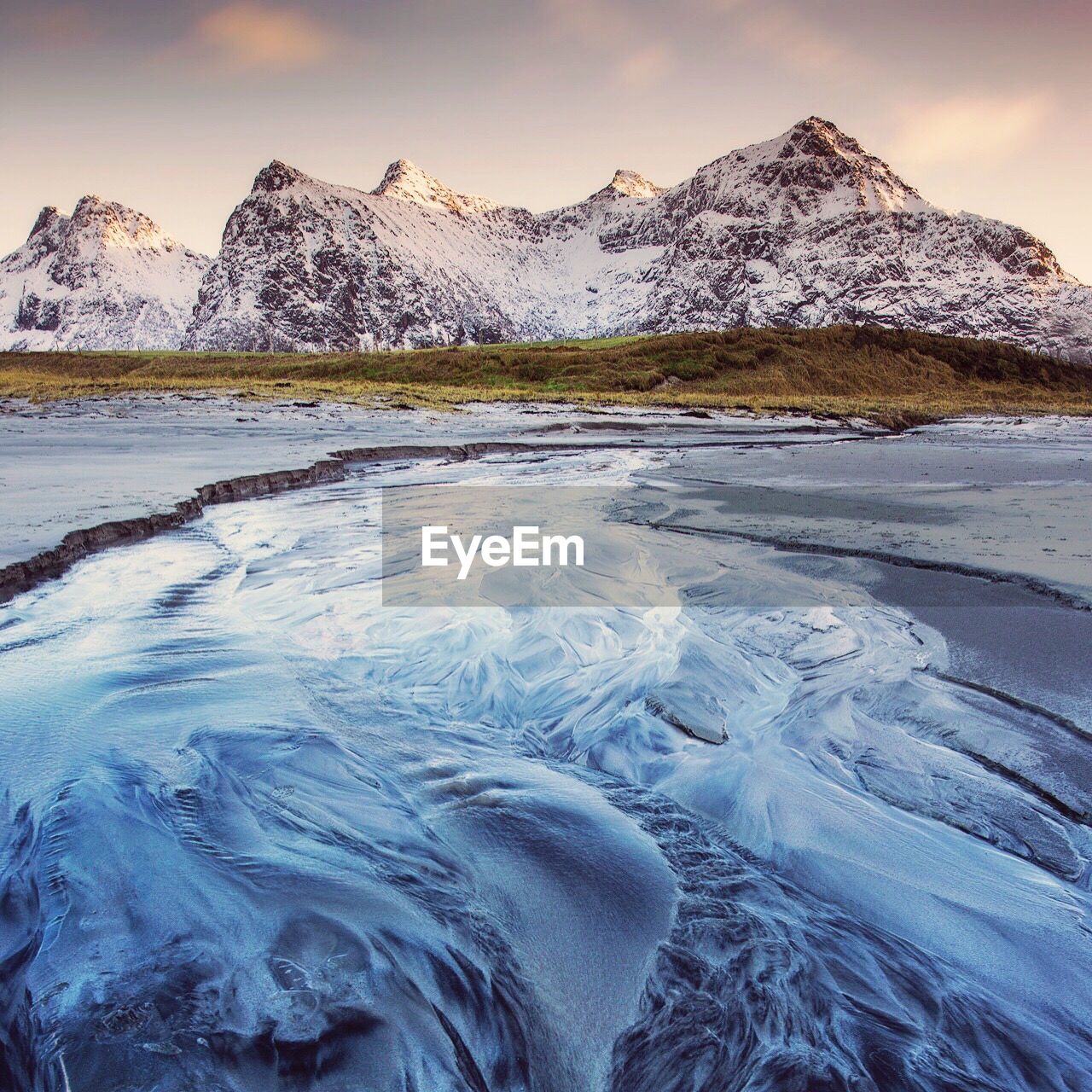 Scenic view of frozen lake against sky during sunset