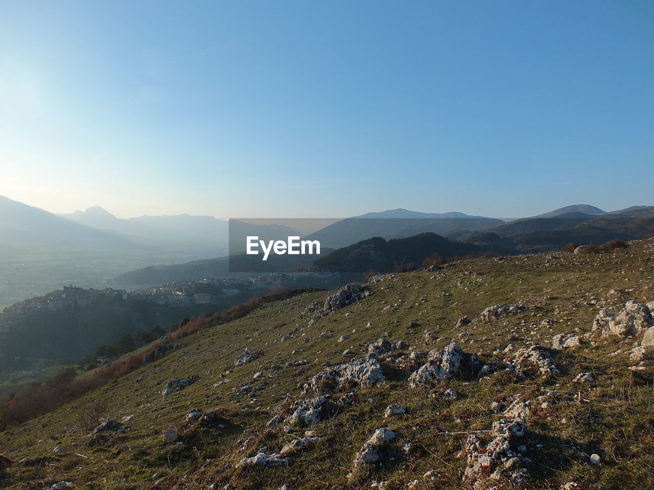 Scenic view of mountains against clear blue sky