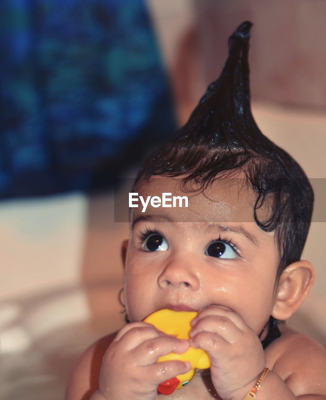 Close-up of cute baby girl chewing rubber duck