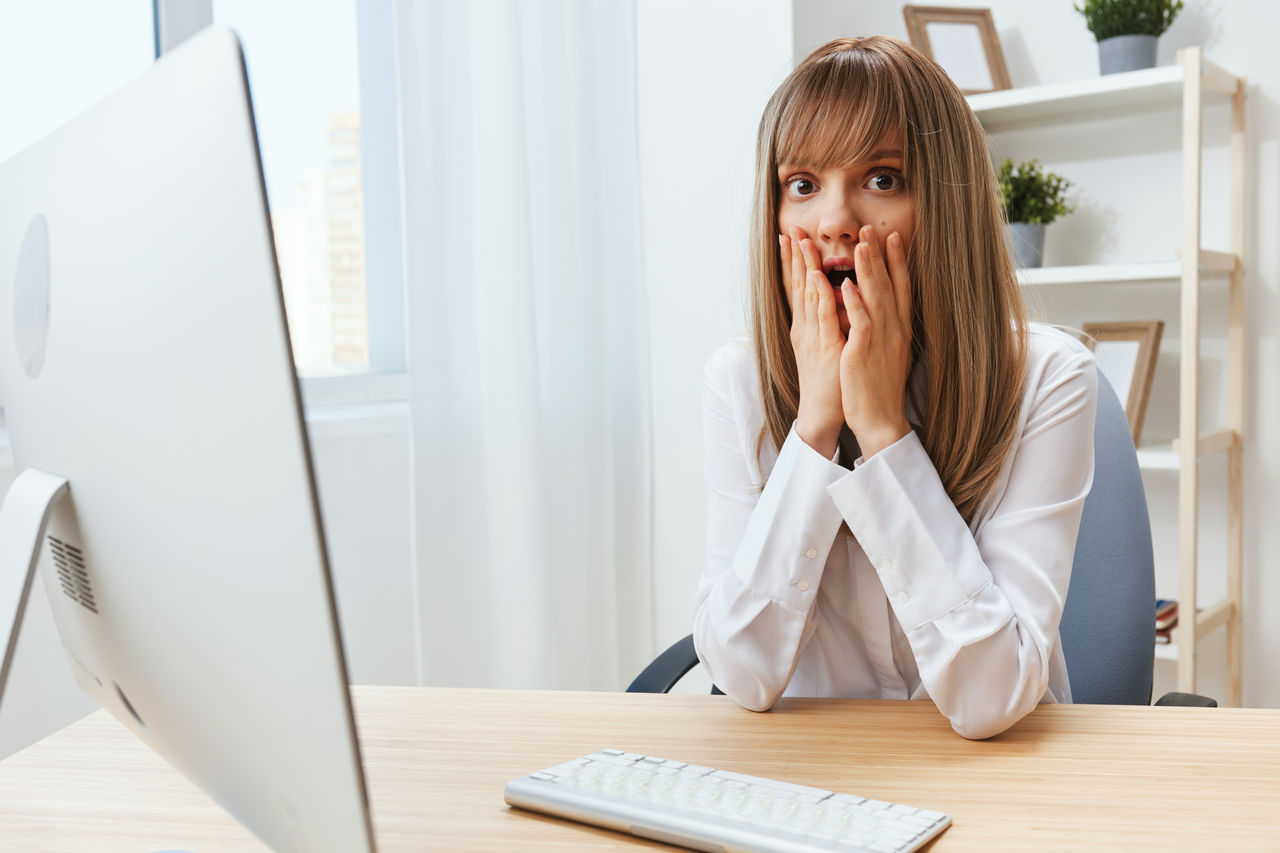 side view of young woman using mobile phone while working at office