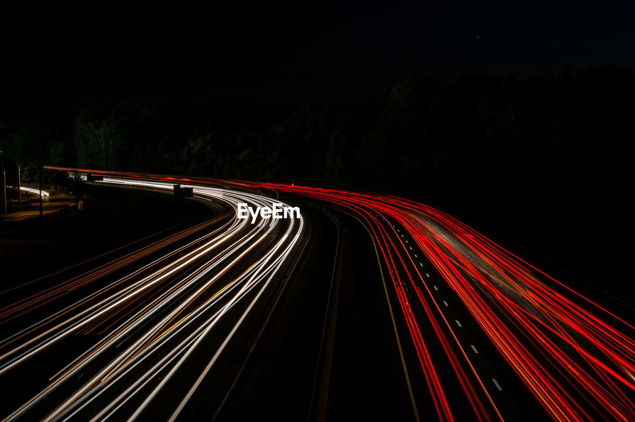 High angle view of light trails on highway at night