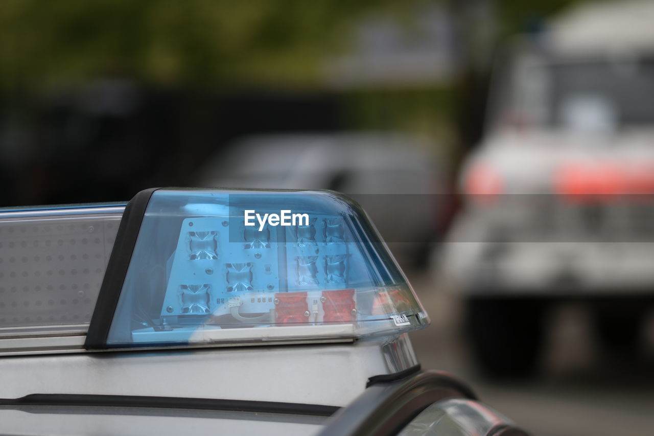 CLOSE-UP OF CAR ON STREET