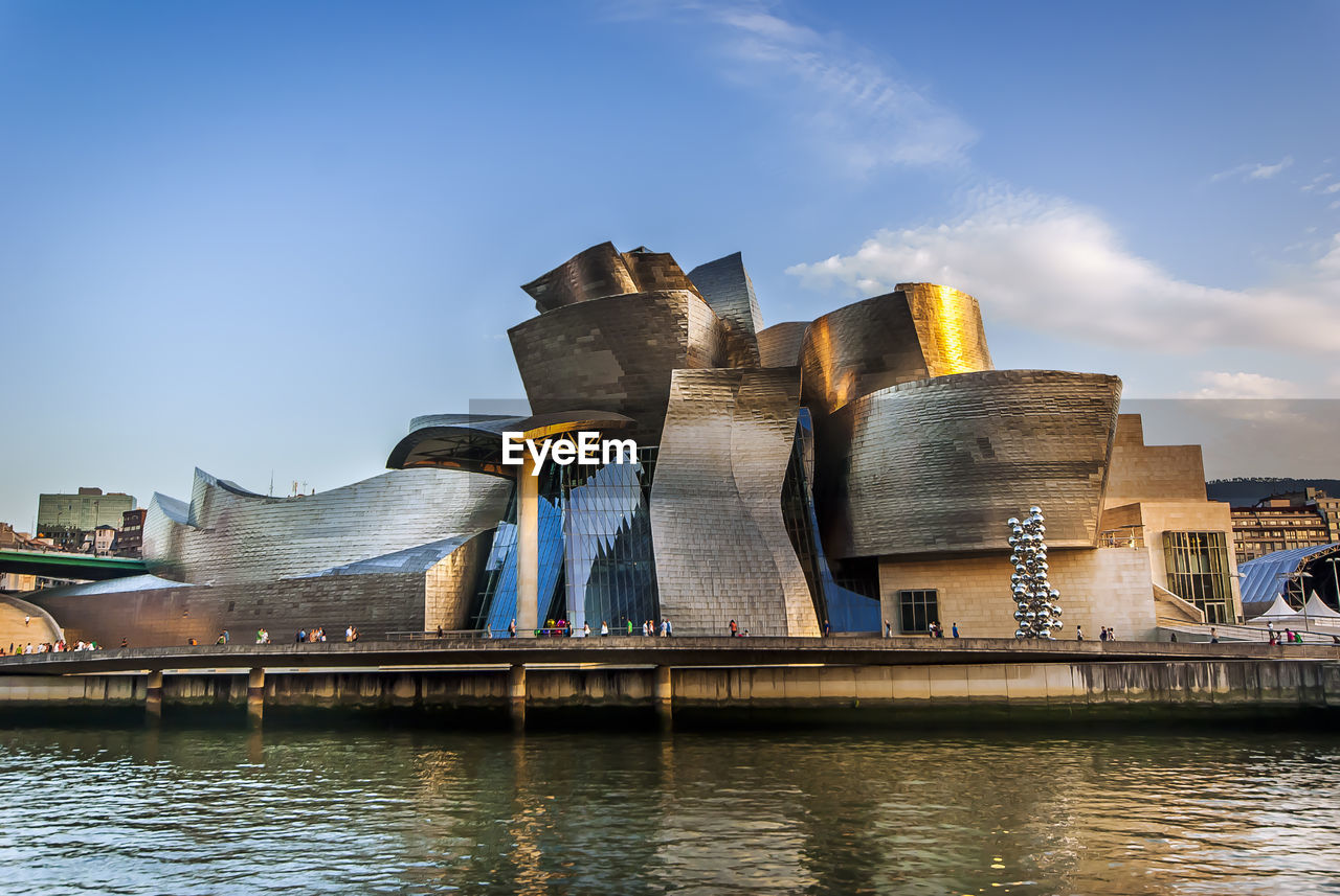 LOW ANGLE VIEW OF BUILDINGS AT WATERFRONT