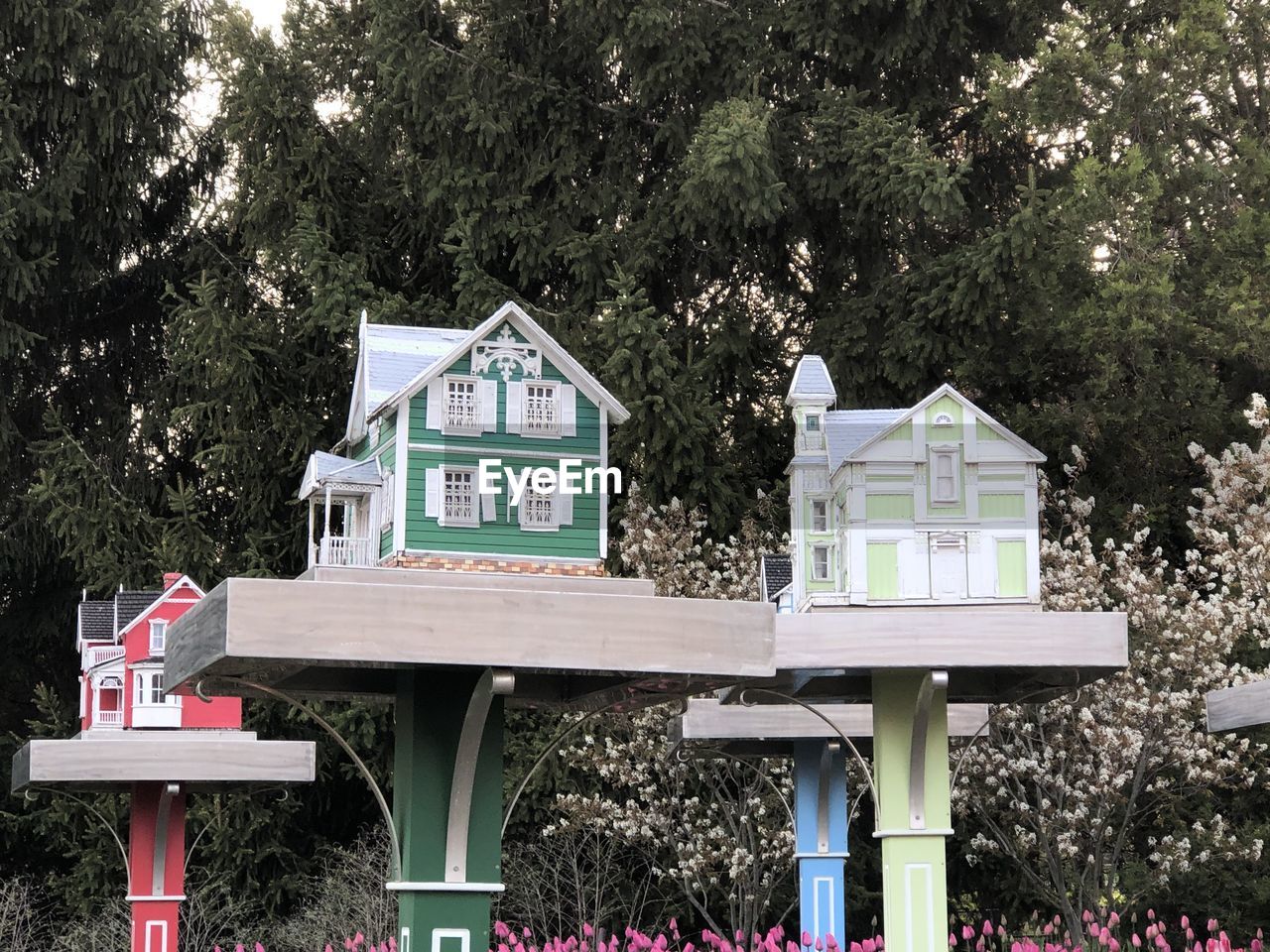 INFORMATION SIGN BY TREES IN PARK AGAINST BUILDING