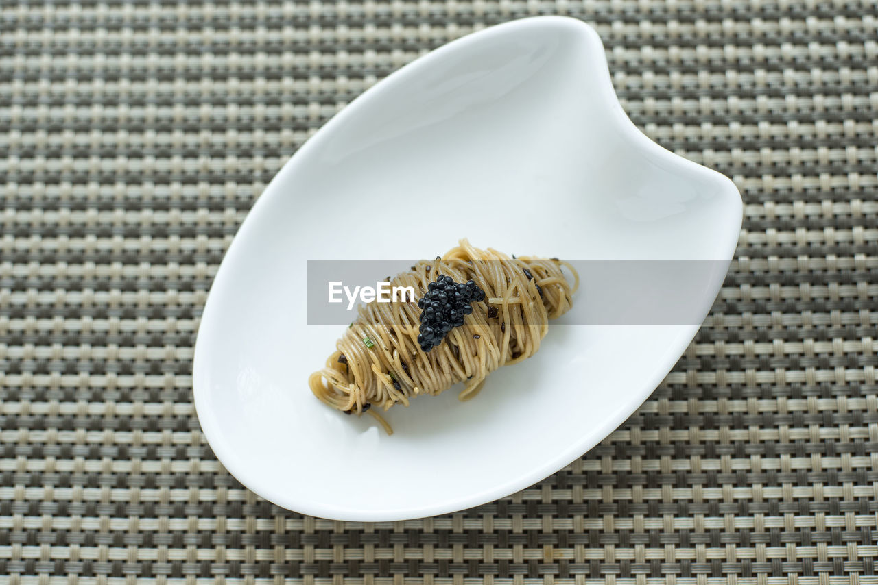 High angle view of angel hair pasta with caviar in plate