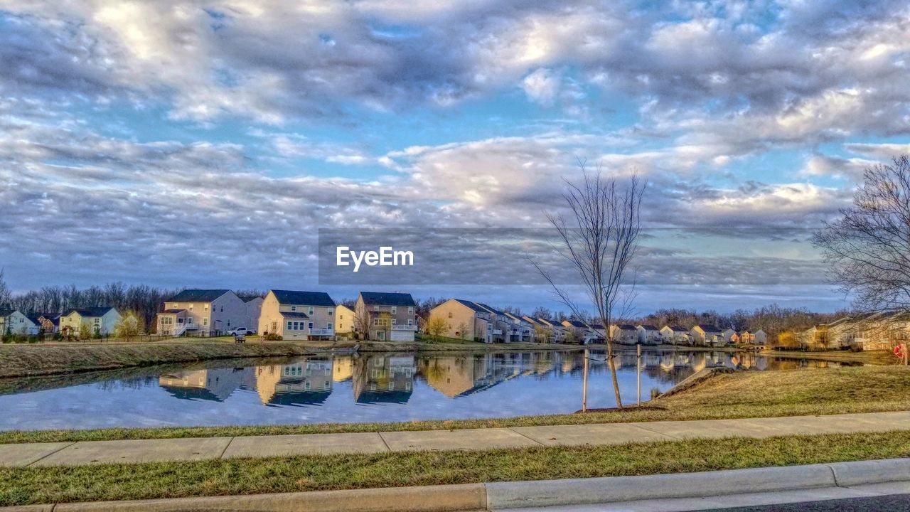 RIVER BY TREES AGAINST SKY