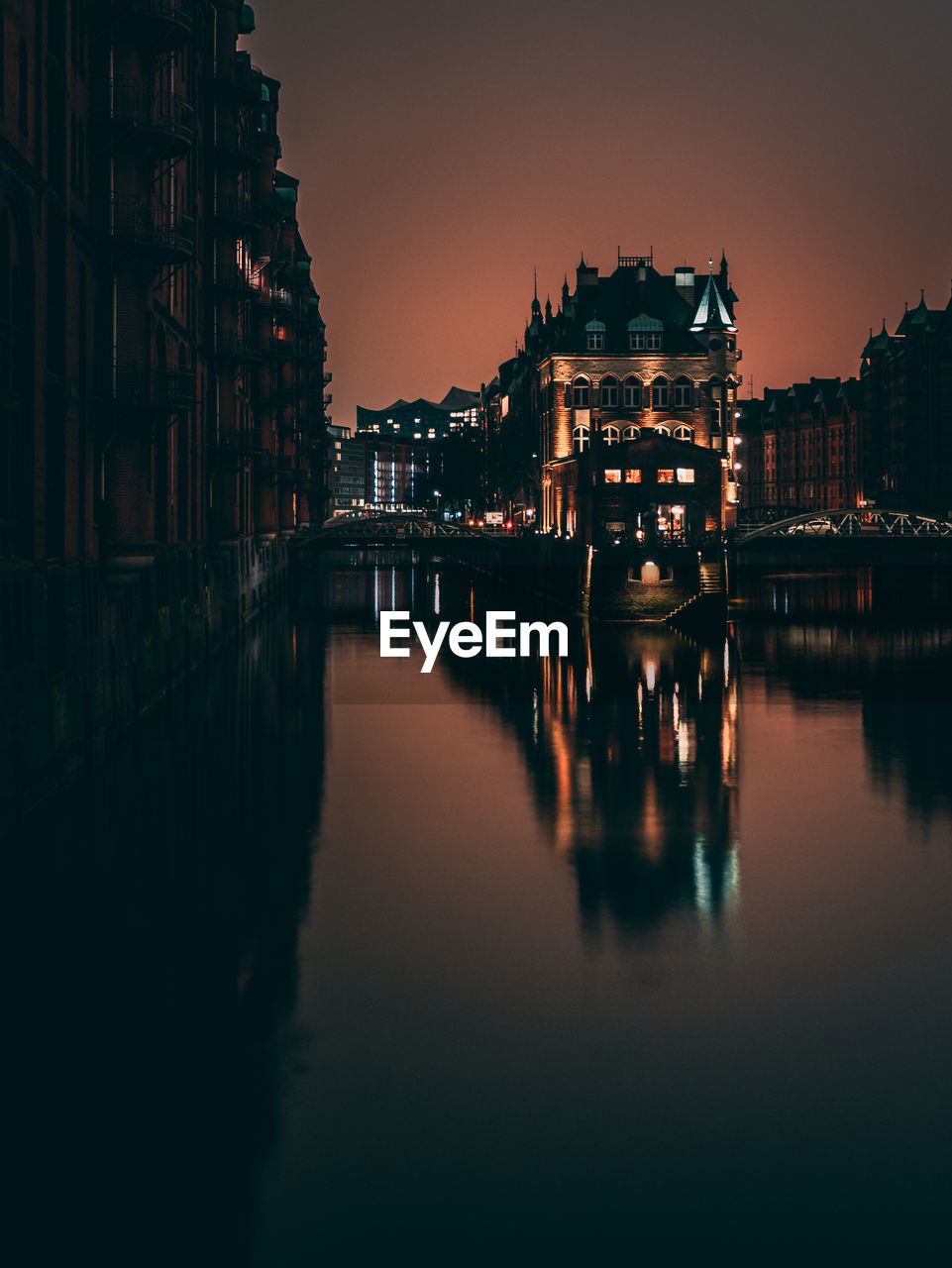 Reflection of buildings in water at night