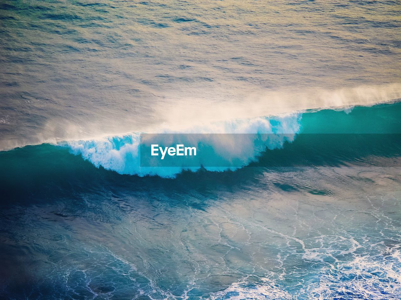 High angle view of waves rushing towards shore