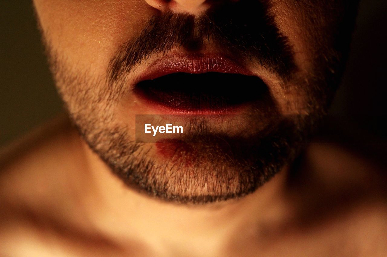 Midsection of man with lipstick and stubble
