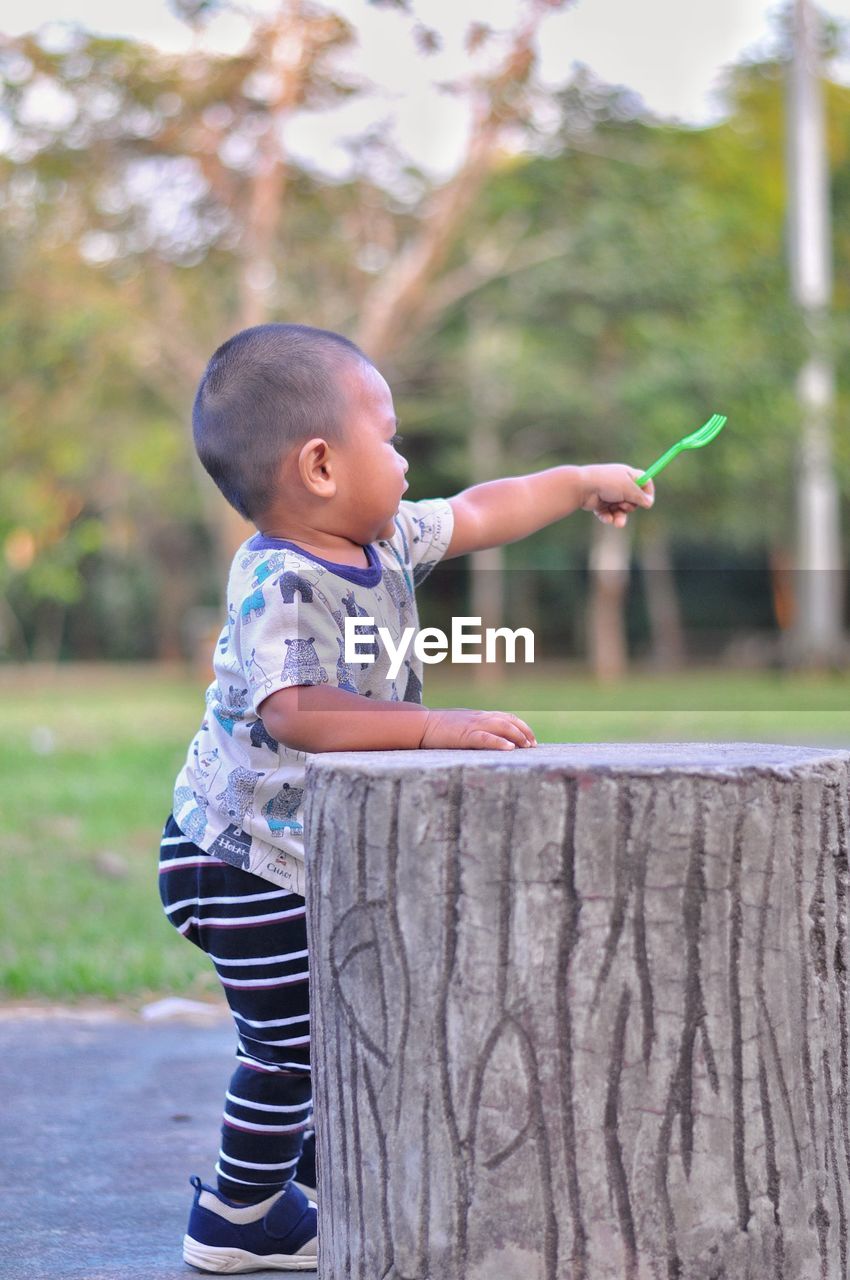 SIDE VIEW OF BOY LOOKING AT CAMERA