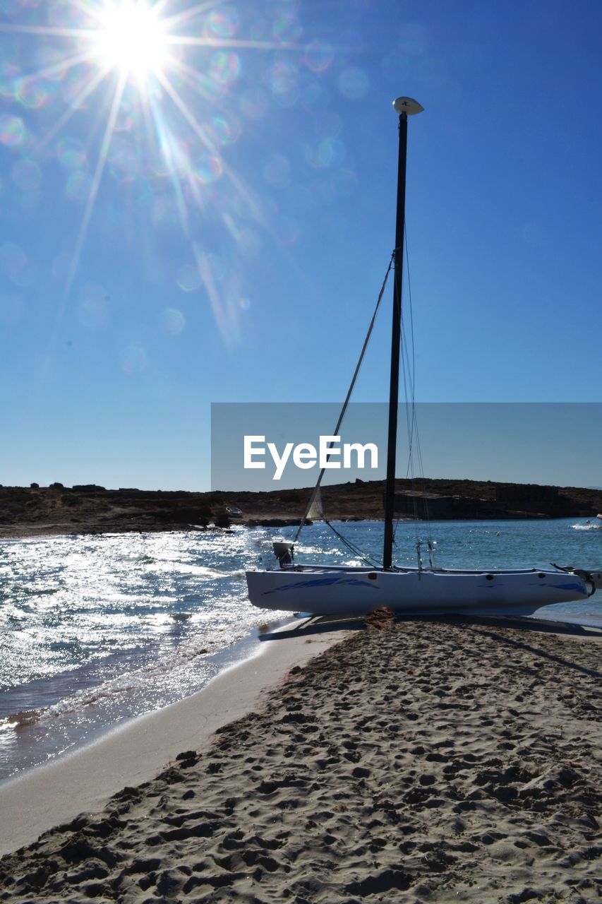 Boat at beach on sunny day