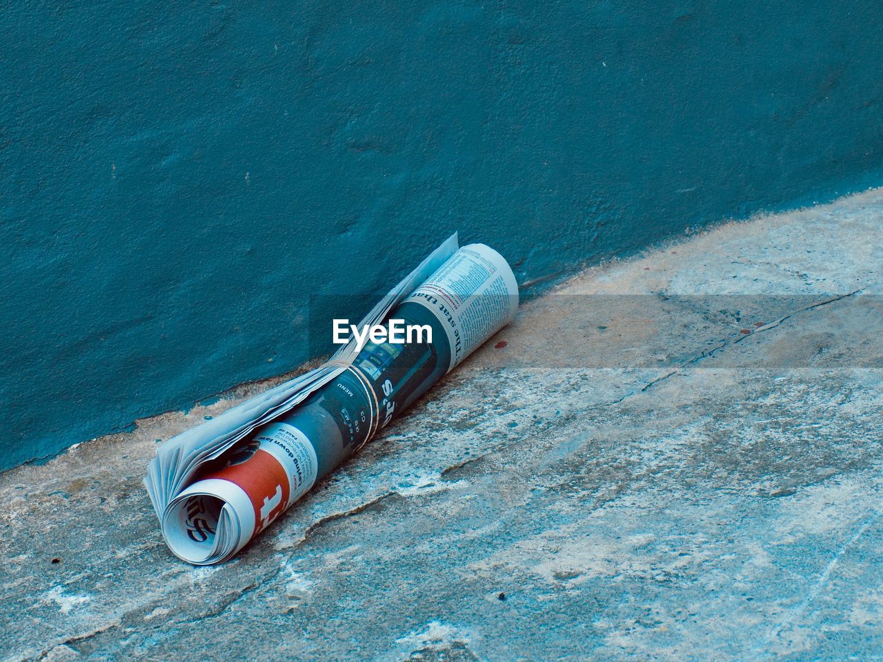 HIGH ANGLE VIEW OF ABANDONED CONTAINER ON SHORE AGAINST WALL