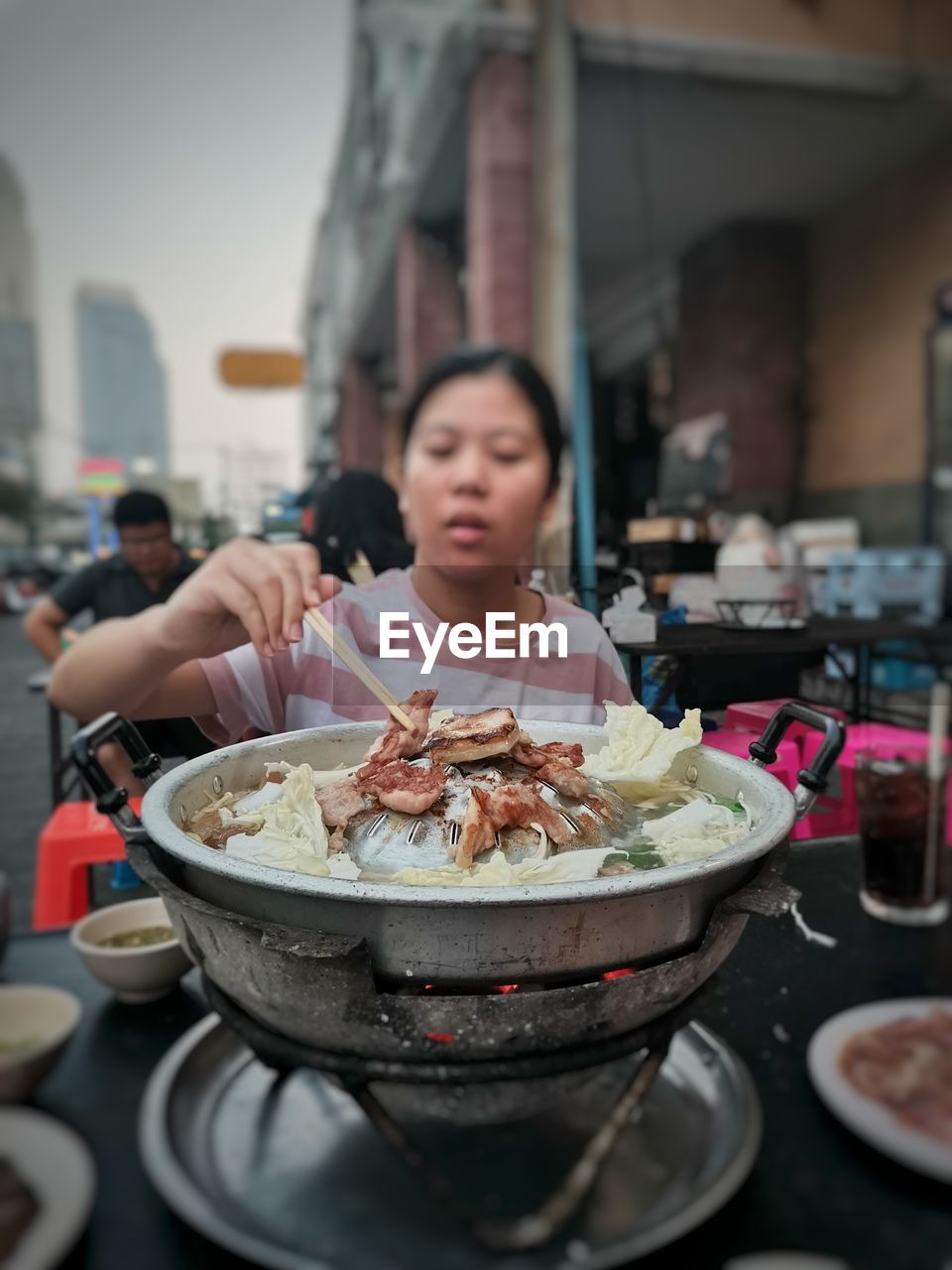 Midsection of woman having food in restaurant