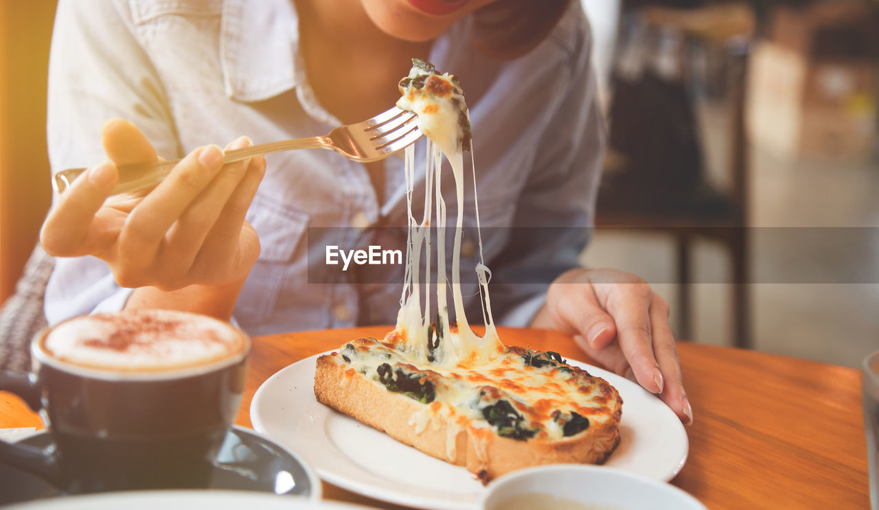 Close-up of woman having pizza