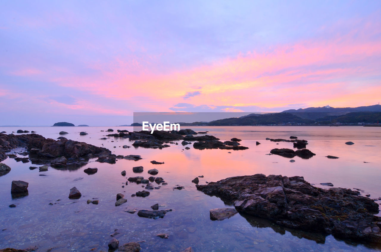 Scenic view of lake against sky during sunset