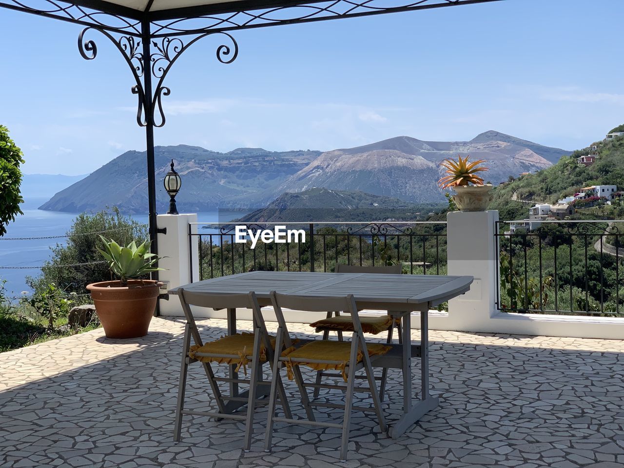 CHAIRS AND TABLES ON TABLE AGAINST MOUNTAINS