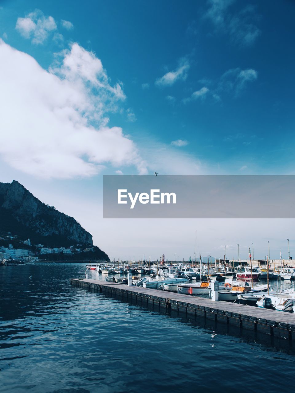 BOATS IN SEA AGAINST CLOUDY SKY