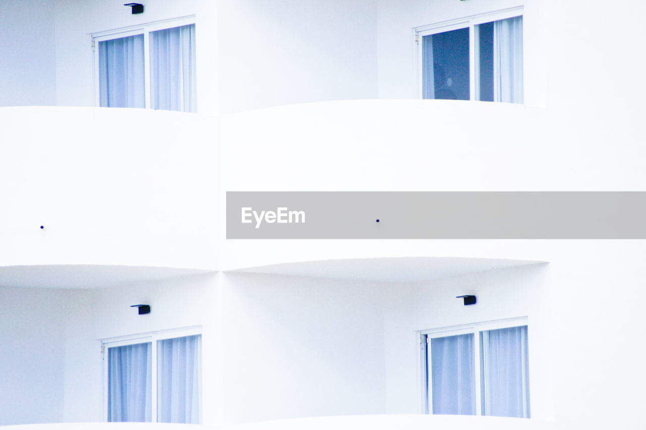 LOW ANGLE VIEW OF WHITE BUILDING AGAINST SKY