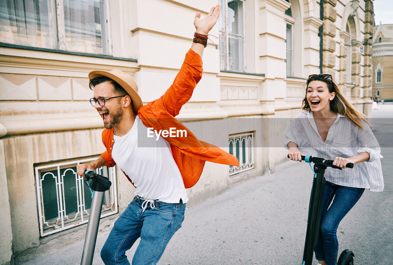 HAPPY YOUNG MAN WITH ARMS RAISED