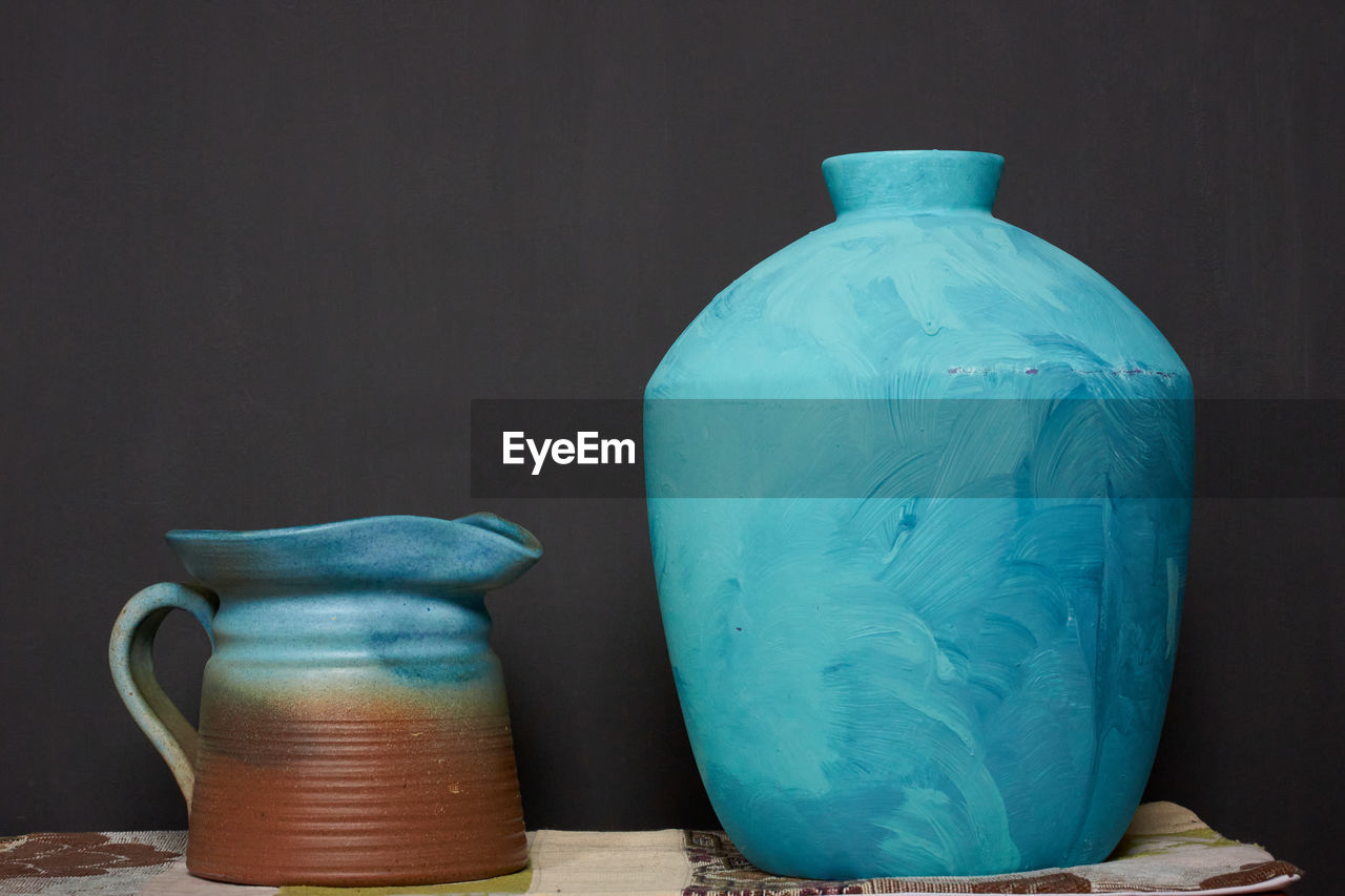 Close-up of pot on table against black background