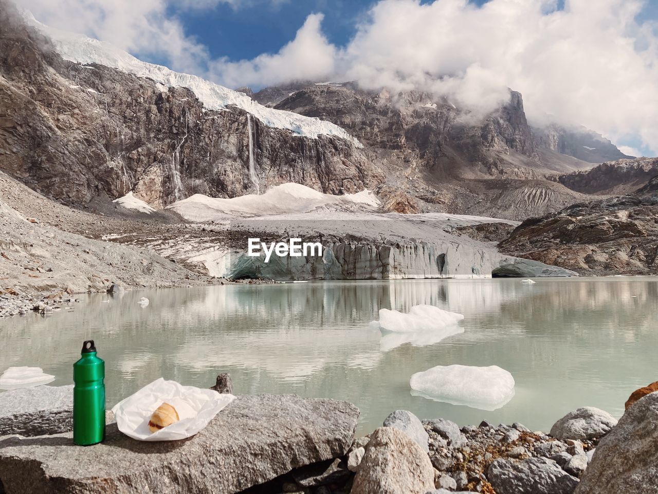 Scenic view of lake and mountains against sky