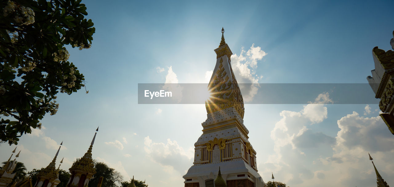 The pagoda of wat phra that panom temple in nakhon phanom in cloudy blue sky day with sunlight