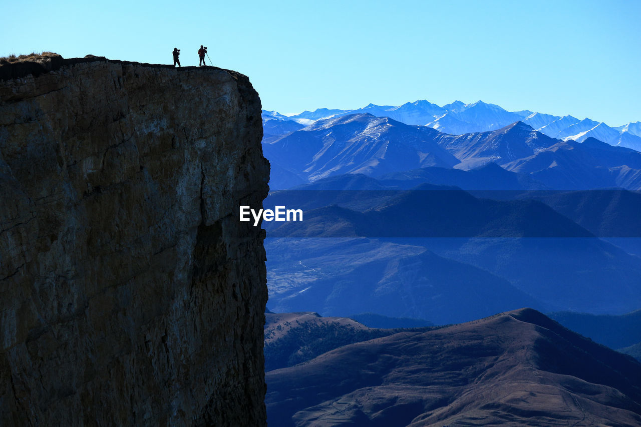 Scenic view of mountain range against clear blue sky