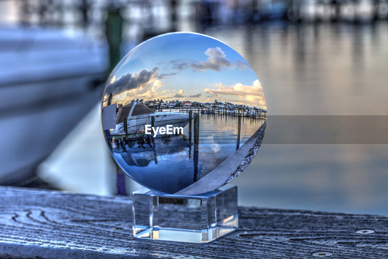 Crystal ball of boats docked at a marina near venetian bay in naples, florida at sunrise.