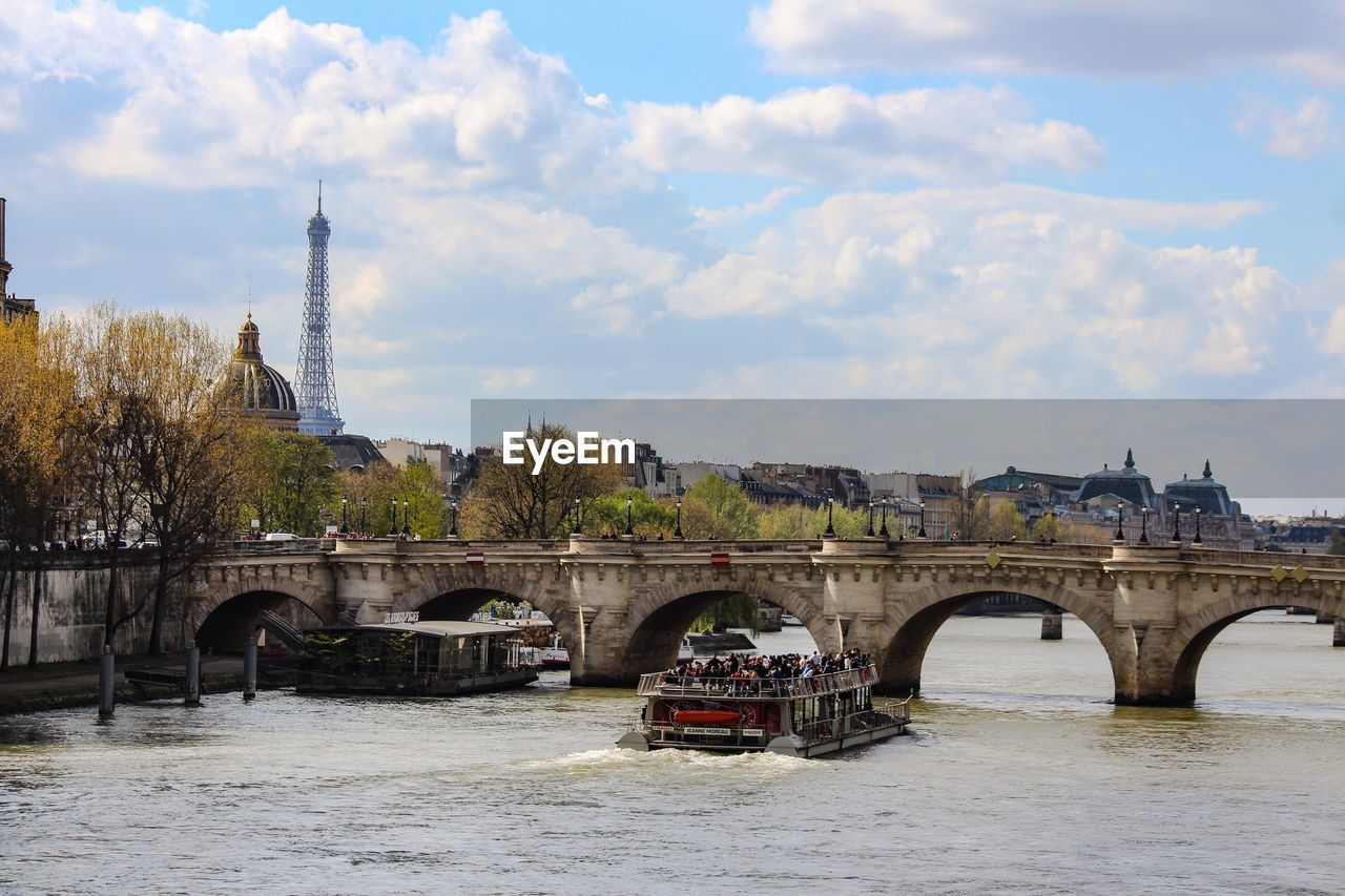 View of bridge over river against cloudy sky