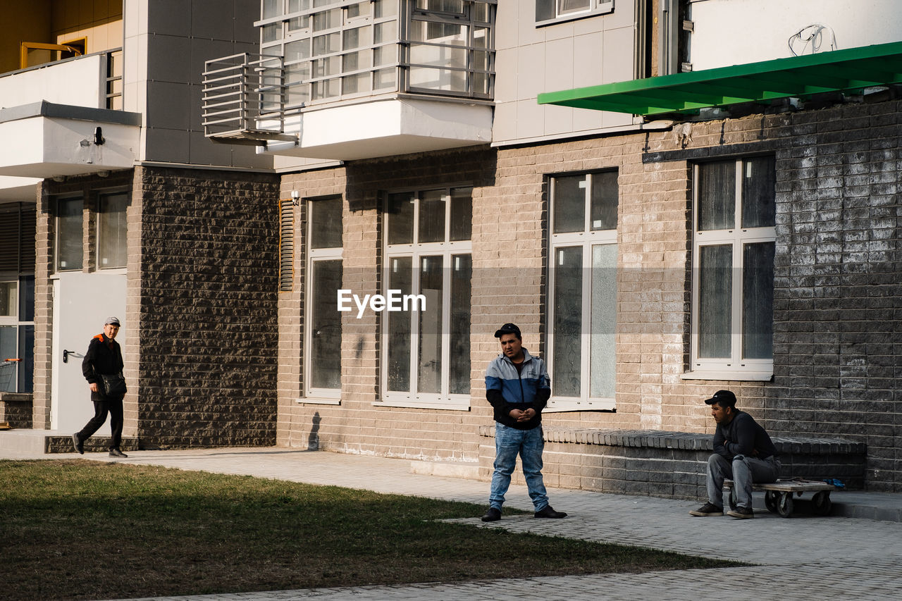 PEOPLE STANDING OUTSIDE BUILDING