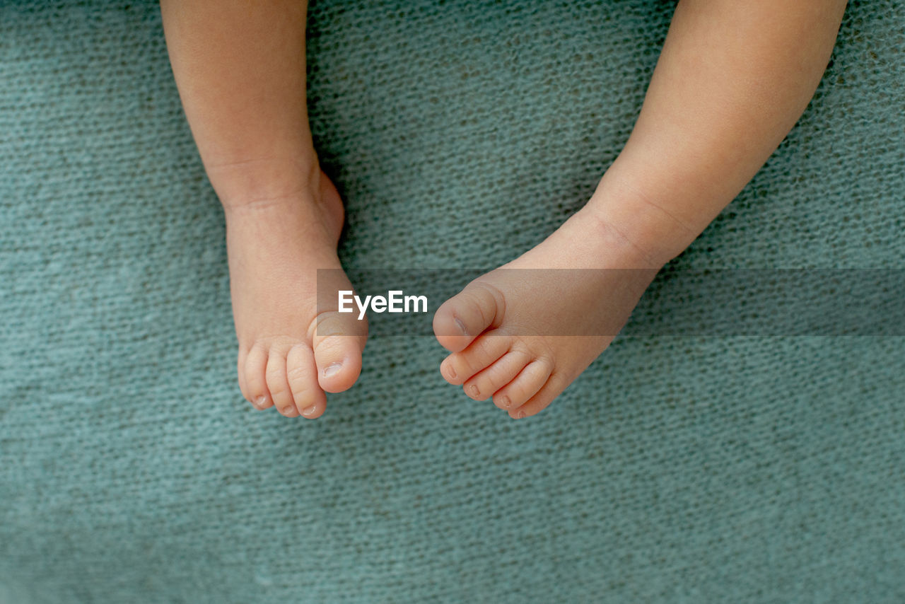 Foot of the newborn baby, tenderness. copy space in winter concept