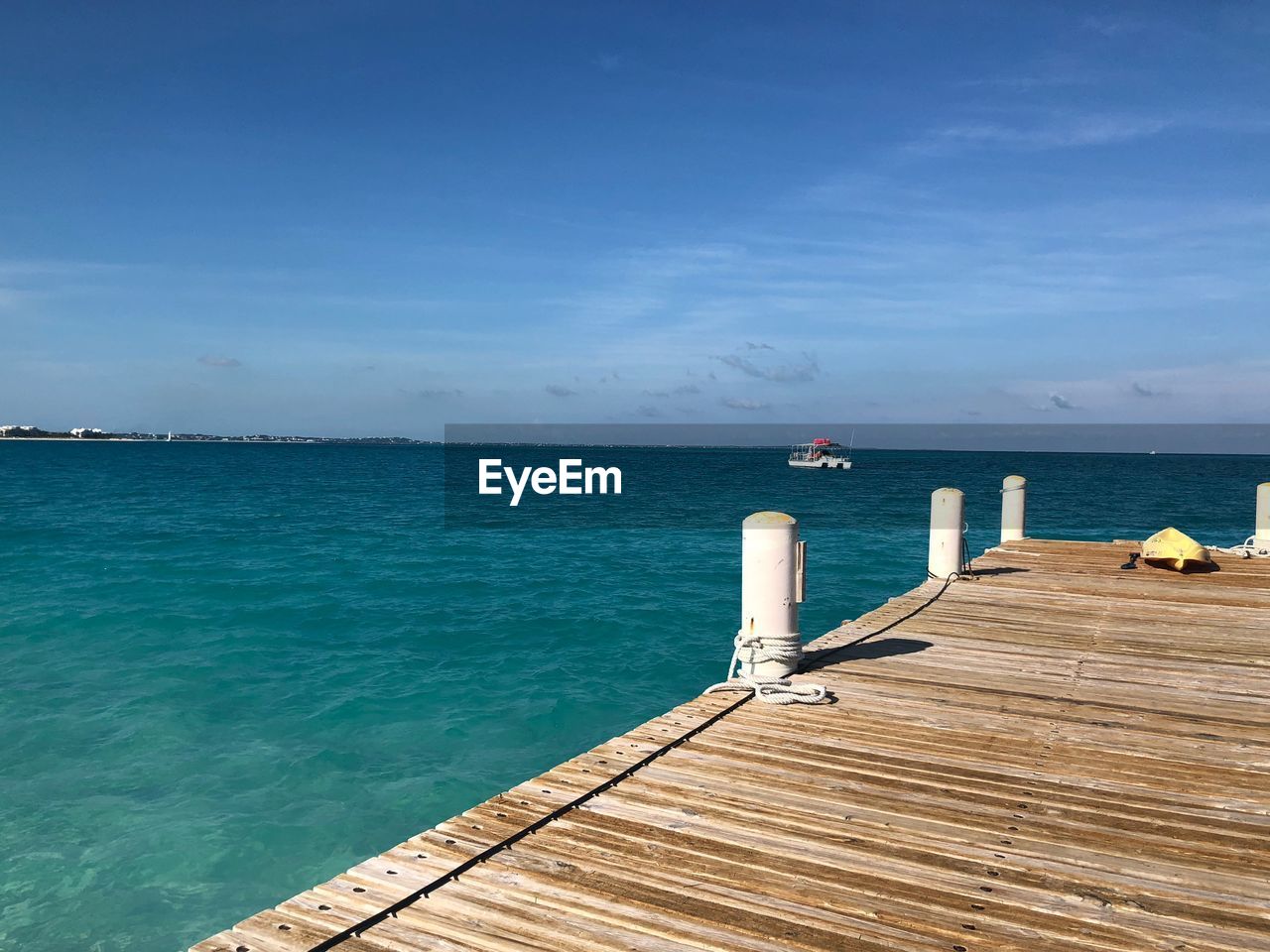 Pier over sea against blue sky