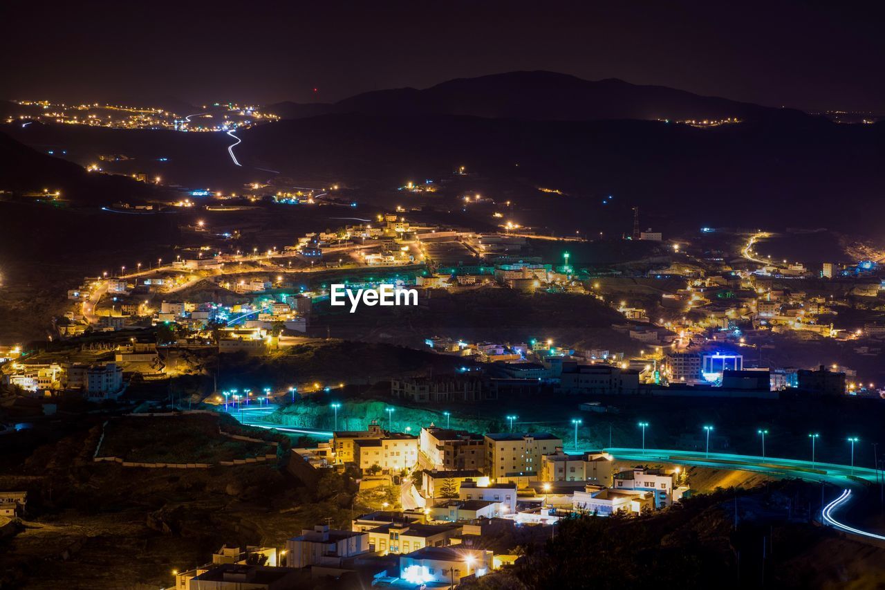 High angle view of illuminated buildings in city at night