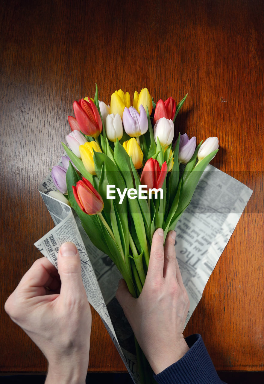 High angle view of woman making bouquet