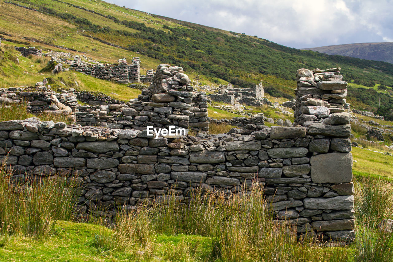 Abandoned stone house on field