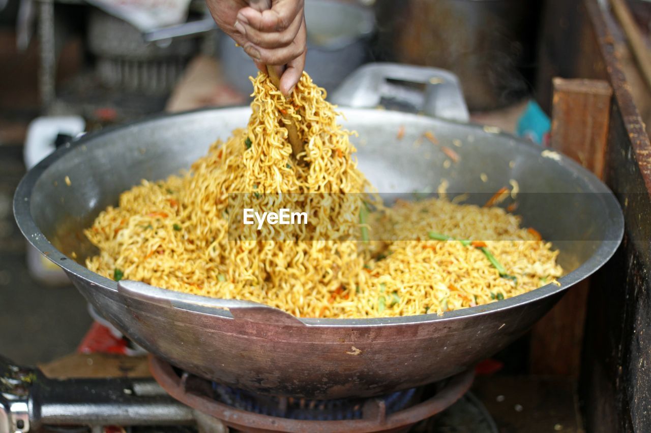 Close-up of man preparing food in market