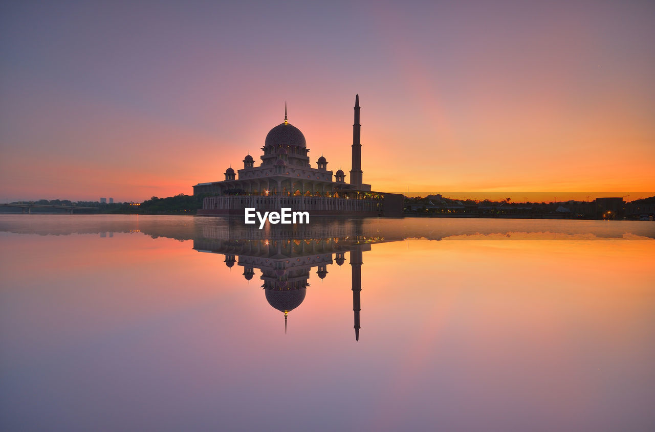 Reflection of temple in river during sunset