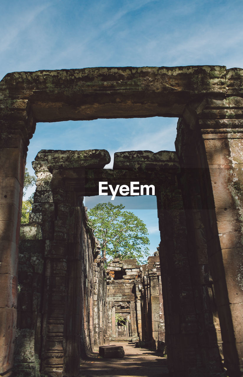 Low angle view of old ruins against sky